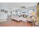Spacious living room features hardwood floors, comfortable seating, ceiling fan, and a large TV at 490 Sanders Farm Ln, Charleston, SC 29492