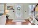 Inviting entryway transitioning to a well-lit living room with hardwood floors and modern furnishings at 490 Sanders Farm Ln, Charleston, SC 29492