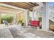 A cozy patio area with stone walkway, comfortable seating, pergola, and bamboo backdrop, ideal for relaxing and entertaining at 490 Sanders Farm Ln, Charleston, SC 29492