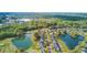 Aerial view shows homes near a golf course and lake, with mature trees enhancing the landscape at 5254 Mulholland Dr, Summerville, SC 29485