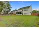 Expansive backyard featuring a firepit, lush green grass, and screened porch at 5254 Mulholland Dr, Summerville, SC 29485