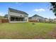 Spacious backyard featuring a fire pit, screened porch, and lush lawn at 5254 Mulholland Dr, Summerville, SC 29485