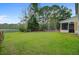 Large, well-manicured backyard with a pond view and mature trees at 5254 Mulholland Dr, Summerville, SC 29485