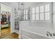 Bright bathroom featuring a marble shower, a garden tub, and a walk-in closet at 5254 Mulholland Dr, Summerville, SC 29485