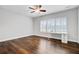 Bright bedroom with plantation shutters on the windows, a ceiling fan, and hardwood floors at 5254 Mulholland Dr, Summerville, SC 29485