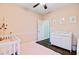 Charming Bedroom with a pink rug, white crib and changing table, and a ceiling fan at 5254 Mulholland Dr, Summerville, SC 29485