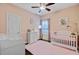 Charming Bedroom with a pink rug, white crib and changing table, and a ceiling fan at 5254 Mulholland Dr, Summerville, SC 29485