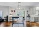 Bright dining area features hardwood floors, stylish light fixture, table and chairs, and access to the outdoor patio at 5254 Mulholland Dr, Summerville, SC 29485