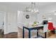 Dining area features a modern light fixture and seating for two, with views of the staircase at 5254 Mulholland Dr, Summerville, SC 29485