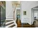 Bright foyer features hardwood floors, staircase, and entry to adjacent rooms at 5254 Mulholland Dr, Summerville, SC 29485