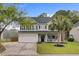 Charming two-story home with a well-maintained lawn, a two car garage and lovely landscaping at 5254 Mulholland Dr, Summerville, SC 29485