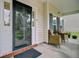 Cozy front porch featuring seating area with wicker chairs and an ornate glass door at 5254 Mulholland Dr, Summerville, SC 29485