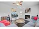 Cozy living room with a fireplace, large screen TV, comfortable seating, and lots of natural light at 5254 Mulholland Dr, Summerville, SC 29485