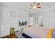 A serene main bedroom with television, ceiling fan and white walls at 5254 Mulholland Dr, Summerville, SC 29485