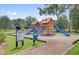 Community playground with wooden play structure and blue slides for outdoor fun at 5254 Mulholland Dr, Summerville, SC 29485