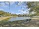 Scenic pond with bench seating providing a serene view of the surrounding landscape at 5254 Mulholland Dr, Summerville, SC 29485