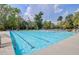 Large, clear swimming pool with multiple lanes surrounded by lush greenery at 5254 Mulholland Dr, Summerville, SC 29485