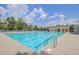 A pristine community pool with many lounge chairs surrounding it for relaxation at 5254 Mulholland Dr, Summerville, SC 29485
