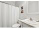 Clean bathroom featuring a shower with white curtain, toilet, and vanity with a white sink at 5638 Dixie Plantation Rd, Hollywood, SC 29449