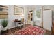 Cozy home office with desk, chair, stylish décor, and a red patterned rug over hardwood flooring at 5638 Dixie Plantation Rd, Hollywood, SC 29449