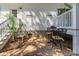 Charming patio with white siding, a small table with chairs, a potted plant, and gravel ground at 5638 Dixie Plantation Rd, Hollywood, SC 29449