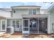 Backyard view featuring the home's siding and a screened-in porch at 601 Buckthorn Cir, Summerville, SC 29483