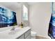 Bright bathroom featuring a single sink vanity, toilet and a window with blinds at 601 Buckthorn Cir, Summerville, SC 29483