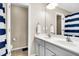 Bathroom with a double sink vanity, tile floor and a mirror with sconce lighting at 601 Buckthorn Cir, Summerville, SC 29483