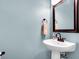 Powder room features a pedestal sink, bronze faucet, and framed mirror at 601 Buckthorn Cir, Summerville, SC 29483