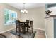 Cozy dining area features a round table, four chairs and natural light from the window at 601 Buckthorn Cir, Summerville, SC 29483