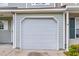 Attached garage with white door and light green siding at 601 Buckthorn Cir, Summerville, SC 29483