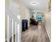 Hallway with wood flooring, white trim and an open living area with a recliner and TV at 601 Buckthorn Cir, Summerville, SC 29483
