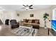 Cozy living room with comfortable seating, ceiling fan, and modern flooring at 601 Buckthorn Cir, Summerville, SC 29483