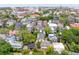 Aerial view of historic Charleston featuring lush trees, colorful rooftops, and the iconic clock tower at 61 Tradd St, Charleston, SC 29401