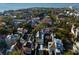 Stunning aerial view of a historic Charleston neighborhood with lush trees and waterfront views at 61 Tradd St, Charleston, SC 29401