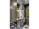 Stylish wet bar with dark cabinets, granite countertops, brass fixtures, and a wine fridge at 61 Tradd St, Charleston, SC 29401