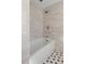 Clean bathroom features a freestanding white bathtub with silver hardware and classic black and white tiling at 61 Tradd St, Charleston, SC 29401