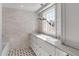 Bright bathroom features a double vanity, and large sun-filled window next to the bathtub at 61 Tradd St, Charleston, SC 29401
