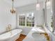 Elegant bathroom with a standalone tub, marble countertops, and stylish fixtures at 61 Tradd St, Charleston, SC 29401