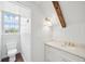 Elegant bathroom with a marble vanity, gold fixtures, and a toilet visible through the doorway with natural light at 61 Tradd St, Charleston, SC 29401
