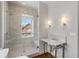Elegantly designed bathroom with a glass-enclosed shower, marble sink, and stylish lighting at 61 Tradd St, Charleston, SC 29401