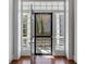 Bright entryway with hardwood floors, large windows, and a stylish front door at 61 Tradd St, Charleston, SC 29401