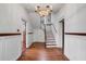 Bright foyer featuring hardwood floors, a staircase, elegant chandelier, and a glimpse of the second floor at 61 Tradd St, Charleston, SC 29401