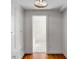 Hallway with hardwood floors, closet, and doorway leading to a bright, tiled bathroom at 61 Tradd St, Charleston, SC 29401