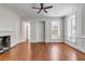Bright living room featuring hardwood floors, a fireplace, and large windows providing ample natural light at 61 Tradd St, Charleston, SC 29401