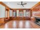 Bright living room with hardwood floors, fireplace, built-in shelving, and large windows at 61 Tradd St, Charleston, SC 29401