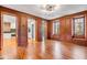 Living room featuring hardwood floors, wood paneling, a fireplace, and views into other rooms at 61 Tradd St, Charleston, SC 29401