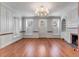 Spacious living room with hardwood floors, built-in shelving, fireplace, and natural light from three windows at 61 Tradd St, Charleston, SC 29401