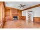 Large living room with hardwood floors, fireplace, built-in shelving, and decorative wood trim at 61 Tradd St, Charleston, SC 29401