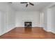 Spacious living room with a fireplace, hardwood floors, and multiple doorways for easy access at 61 Tradd St, Charleston, SC 29401